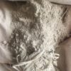 0-3048x4064-1-0-{}-0-12# Pile of light gray powder spilling from a torn bag, with shredded plastic strips nearby; label shows Comixmen Nigeria and Lagos, Nigeria.