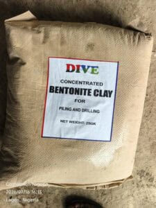 Burlap sack on the ground with a label reading 'DIVE' and 'Concentrated Bentonite Clay' for piling and drilling in Nigeria.